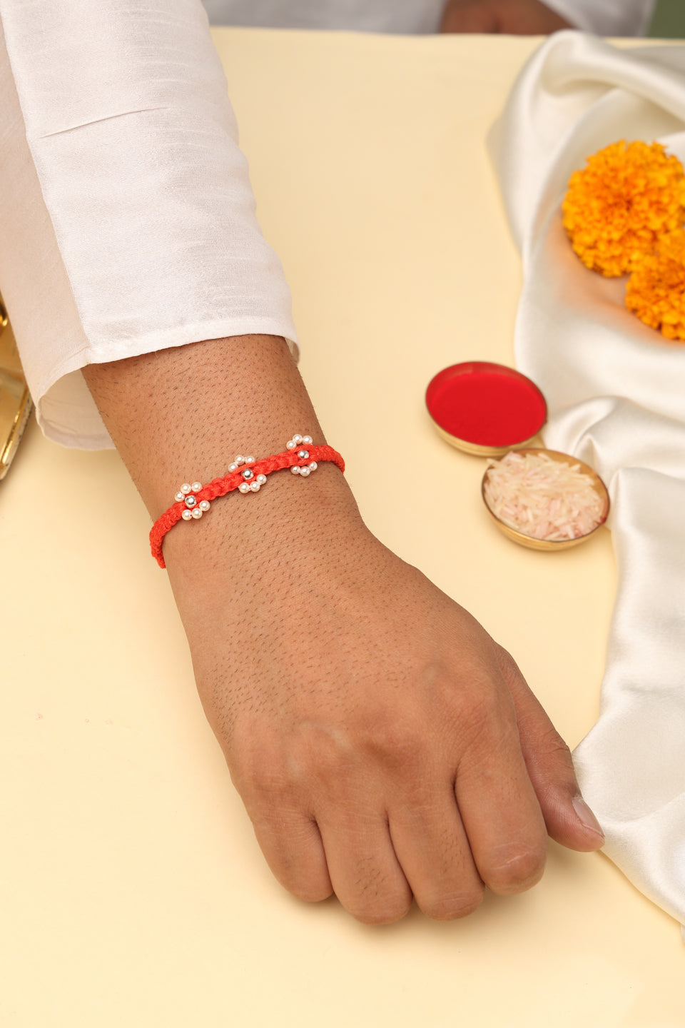 925 Sterling Silver Floral Pearl Rakhi in Red Macrame – Rhodium Plated