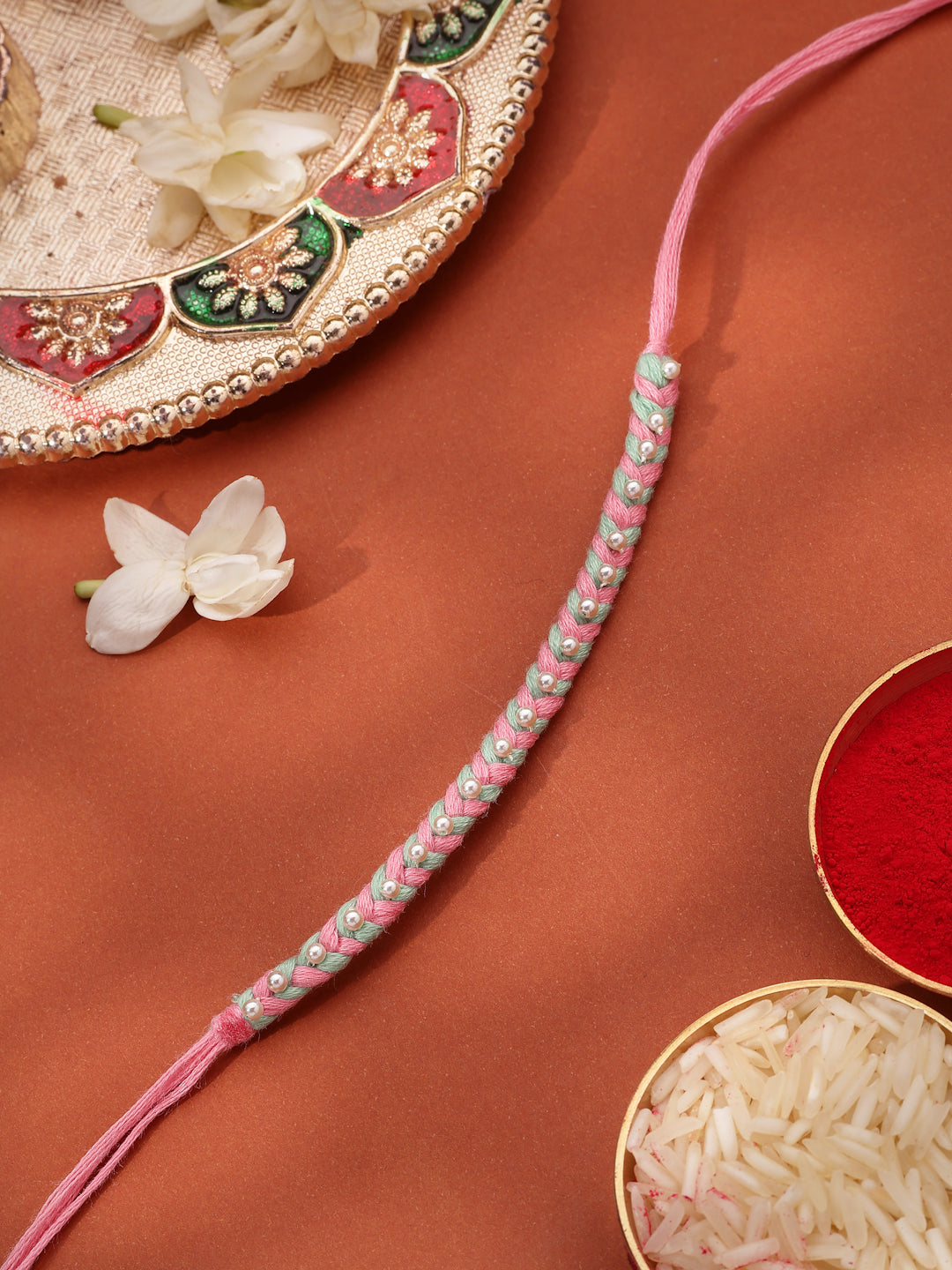 Handcrafted Pink and Green Braided Thread Kids Rakhi with Pearl Accents