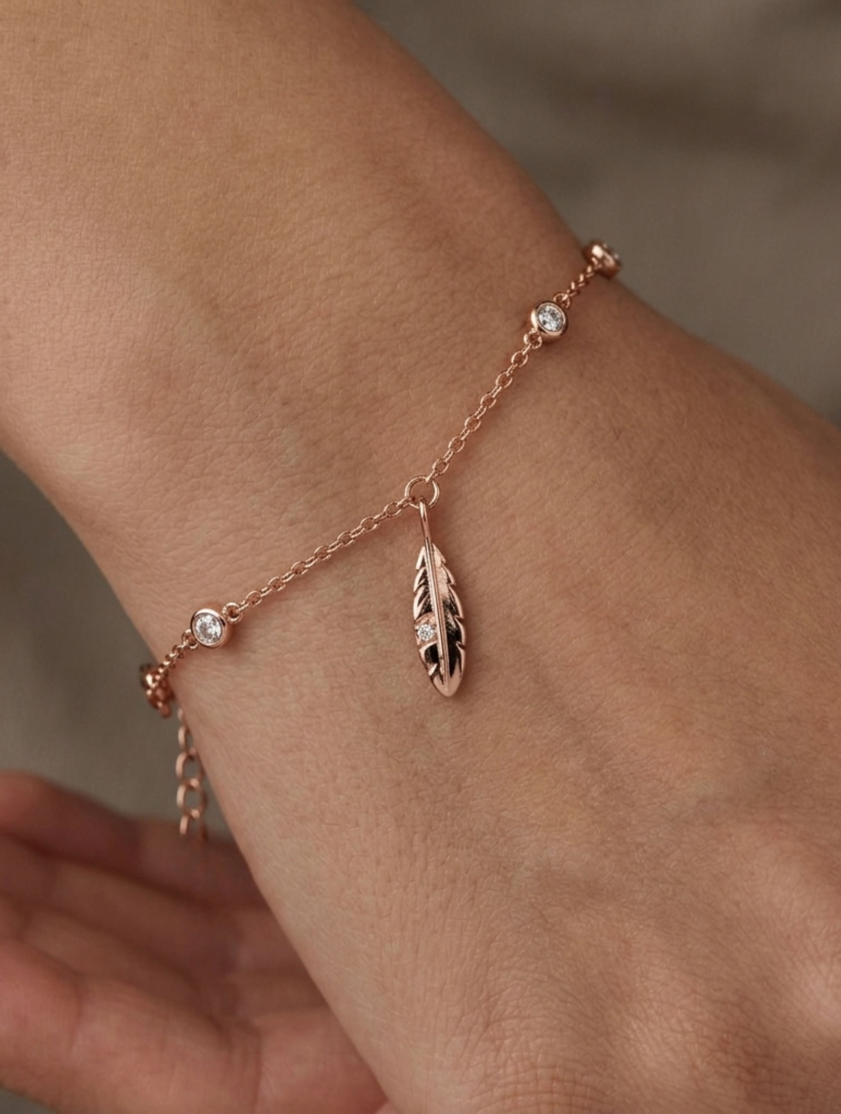 Rose Gold Feather & Shimmering White Stone Accent Charm Bracelet