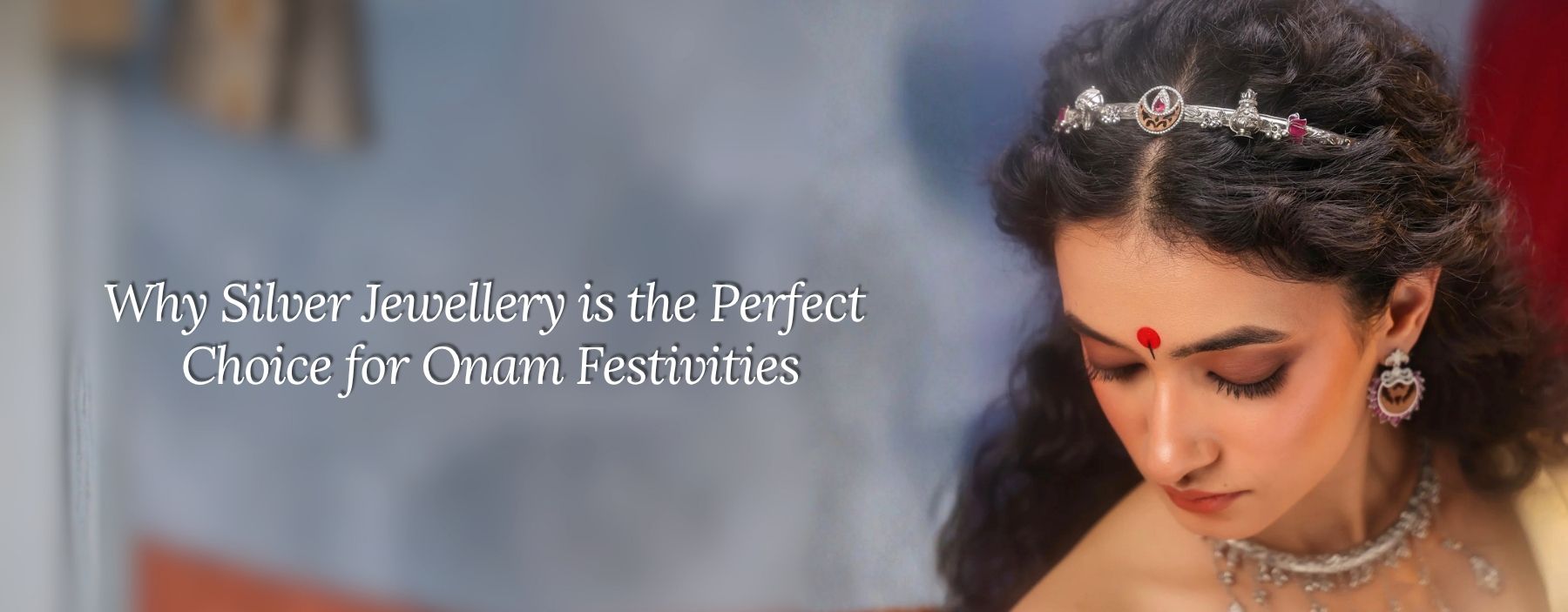 Woman wearing silver necklace, earrings and headpiece for Onam celebrations.
